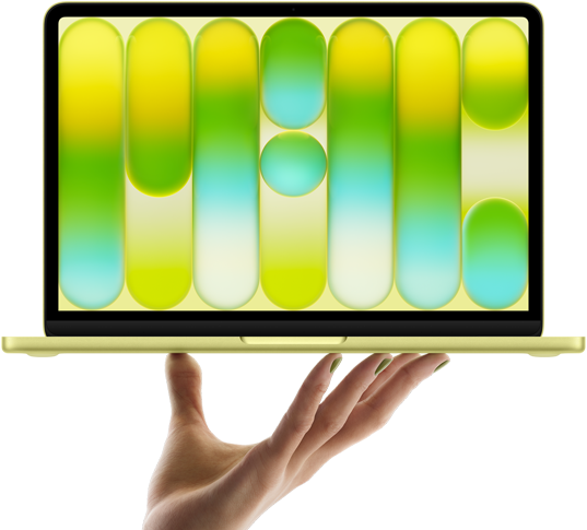 MacBook Neo en color amarillo cítrico, sostenida en equilibrio en la punta de los dedos de una mano abierta, la pantalla muestra un patrón abstracto y colorido